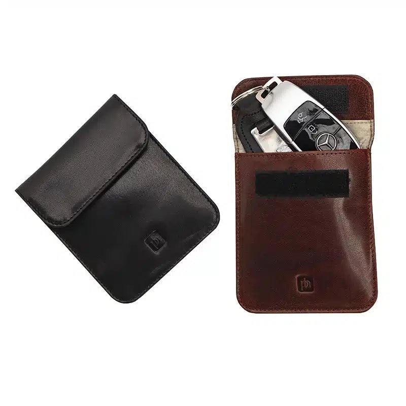 Black and brown leather key holder with a key fob on a white background