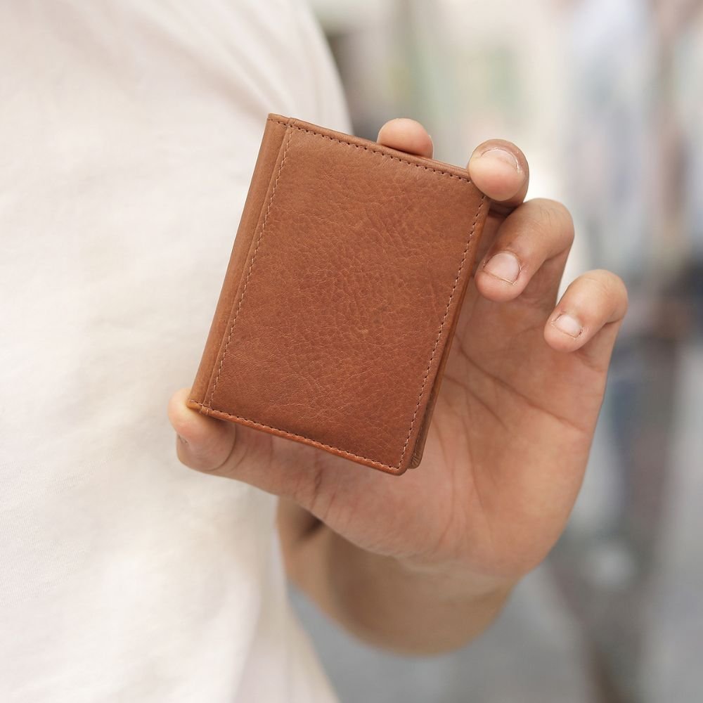 person holding tan tuscan mens credit card holder